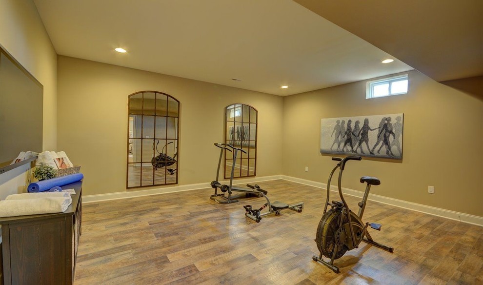 Photo of a large classic home yoga studio in Philadelphia with yellow walls and medium hardwood flooring.
