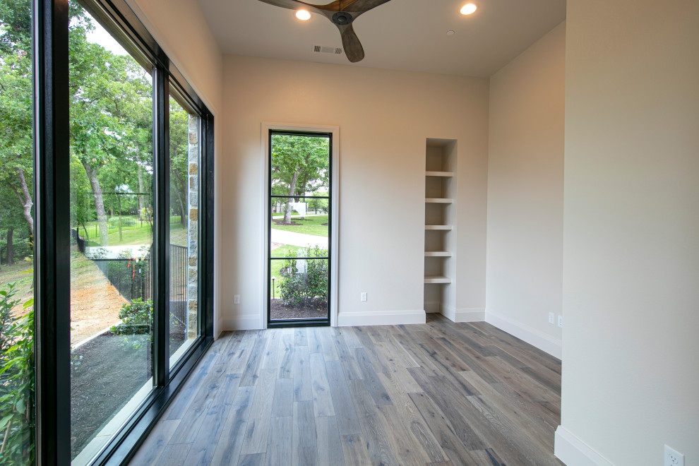 Design ideas for a medium sized home yoga studio in Dallas with beige walls and medium hardwood flooring.