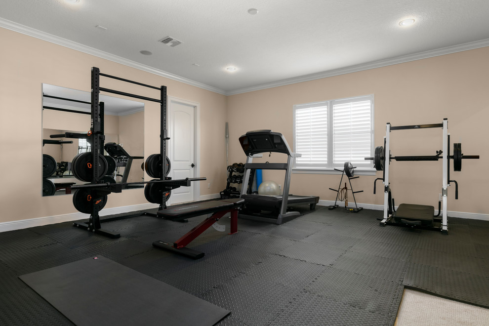 Inspiration for a large mediterranean black floor multiuse home gym remodel in Orlando with orange walls