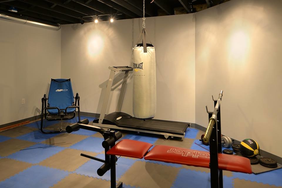 Photo of a medium sized urban home weight room in New York with white walls.