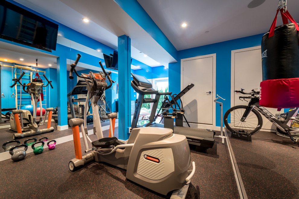 This is an example of a small contemporary multi-use home gym in Vancouver with blue walls, ceramic flooring and black floors.