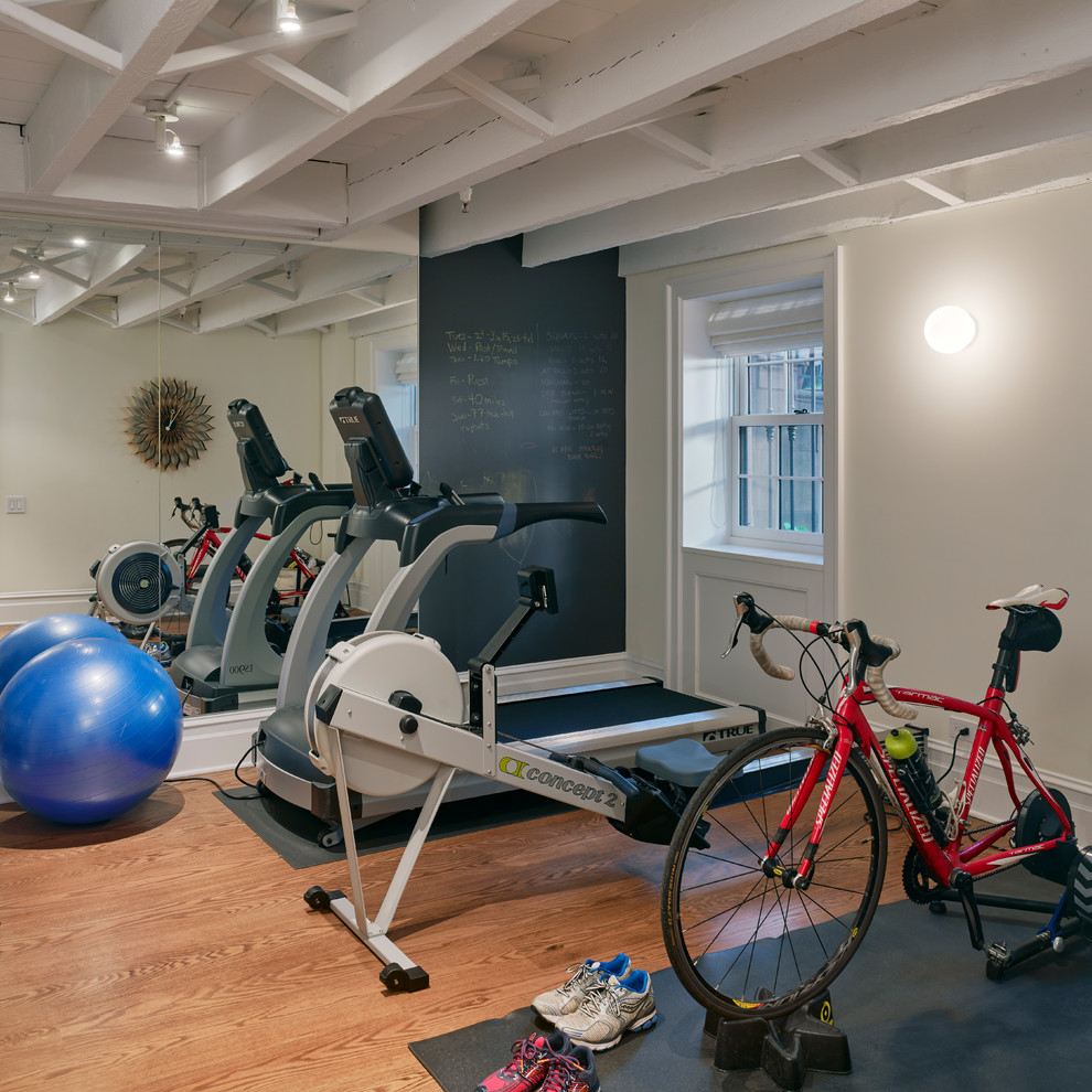 Mid-sized transitional medium tone wood floor multiuse home gym photo in New York with beige walls