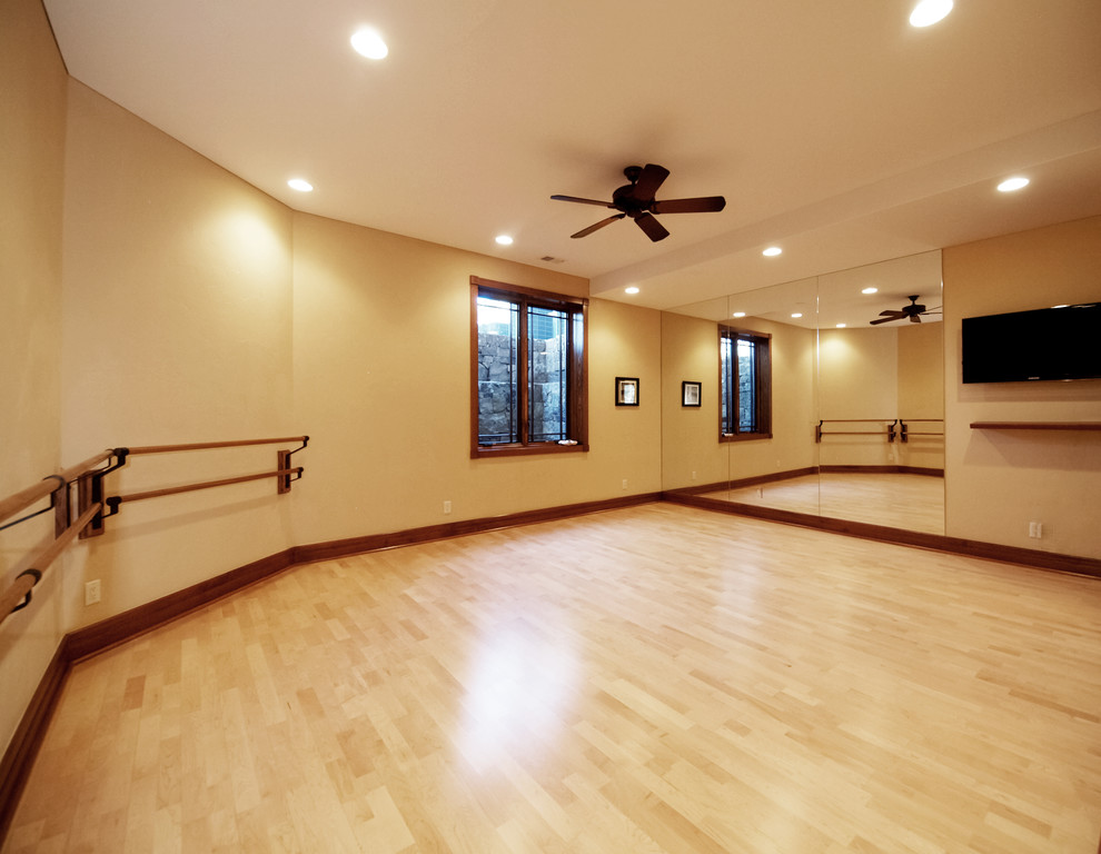 Medium sized traditional multi-use home gym in Denver with beige walls and light hardwood flooring.