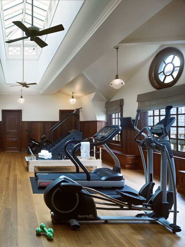 Home weight room - huge mediterranean medium tone wood floor home weight room idea in Chicago with white walls
