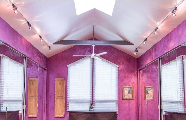 Photo of a large contemporary home yoga studio in Milwaukee with pink walls.