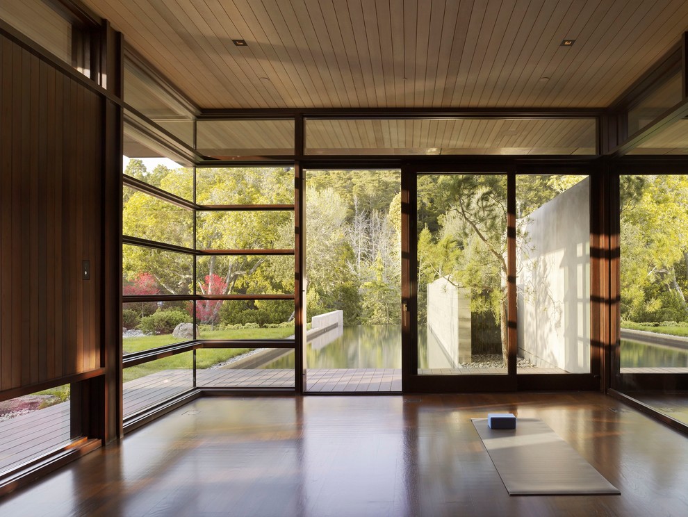 Mid-sized minimalist dark wood floor home yoga studio photo in San Francisco