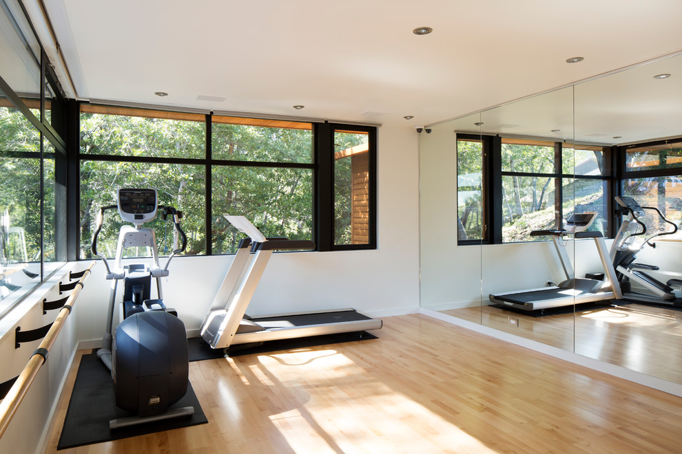Moderner Fitnessraum mit weißer Wandfarbe und hellem Holzboden in San Francisco