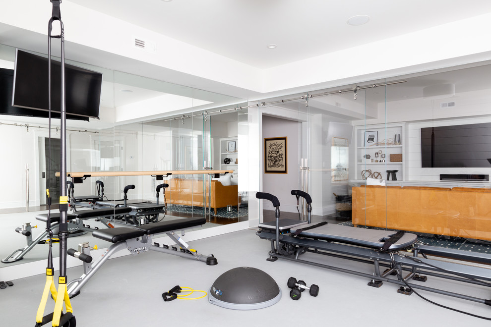 Contemporary multi-use home gym in New York with grey floors.