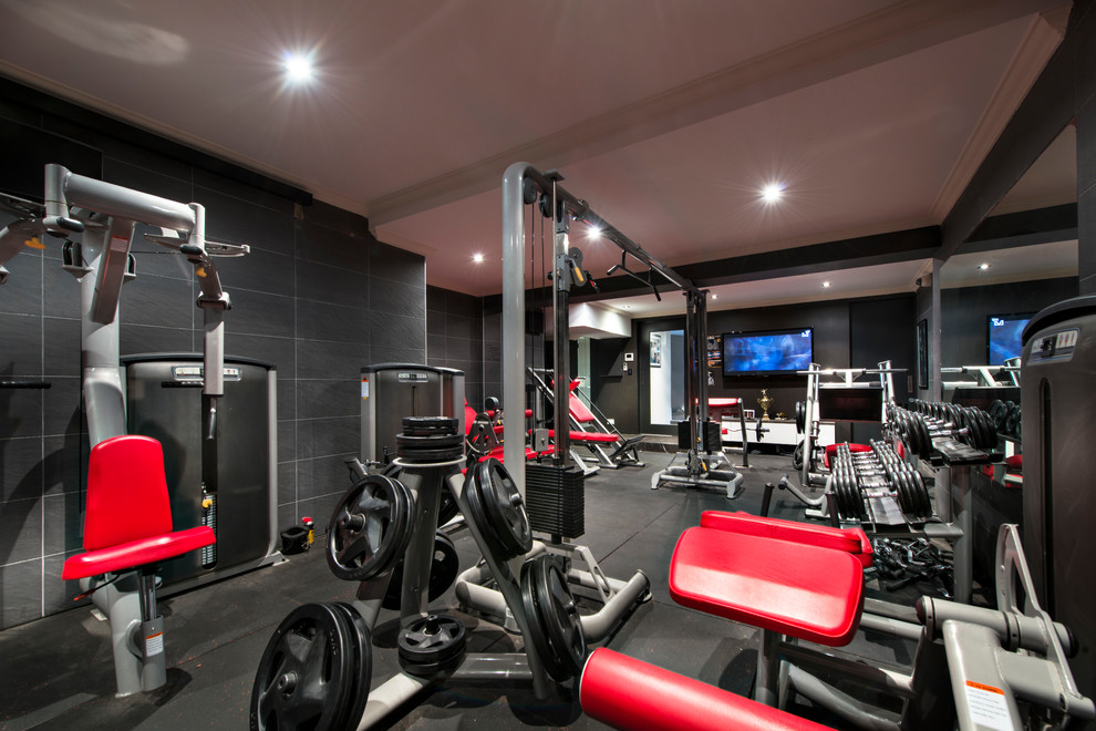 This is an example of a large mediterranean home weight room in Perth with black walls.