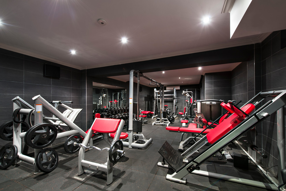 Home weight room - large mediterranean home weight room idea in Perth with black walls