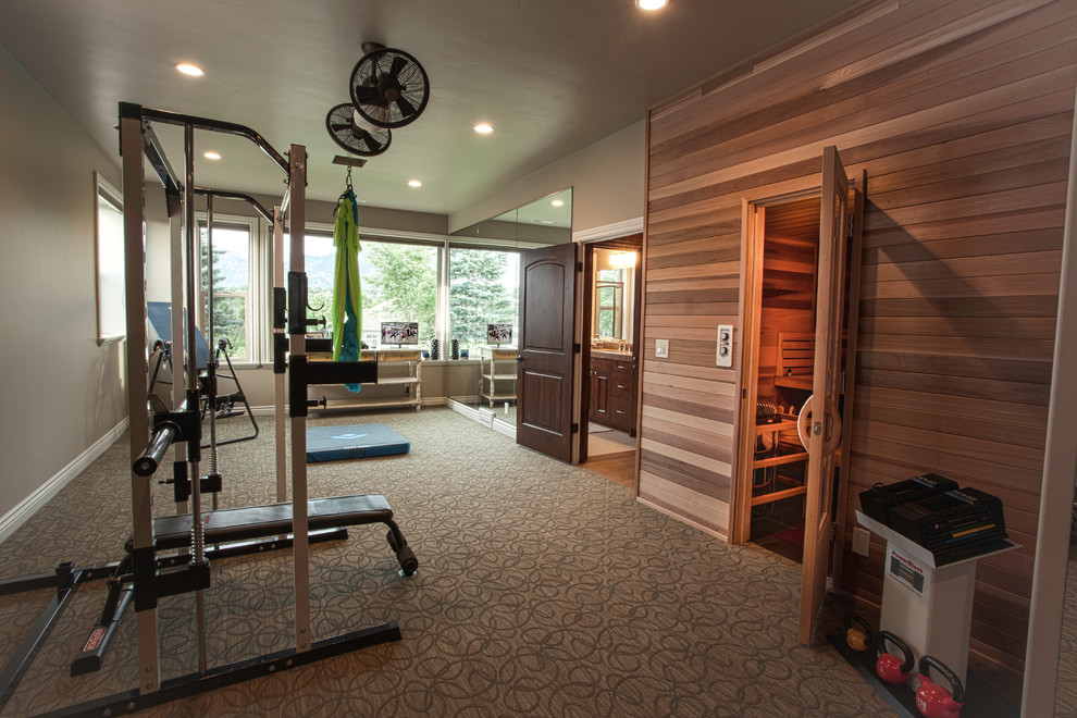 This is an example of a large multi-use home gym in Salt Lake City with beige walls and carpet.