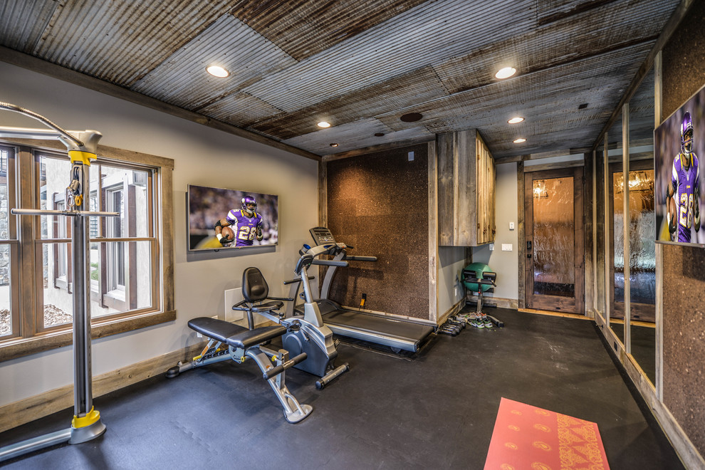 Photo of a medium sized rustic multi-use home gym in Minneapolis with beige walls and grey floors.