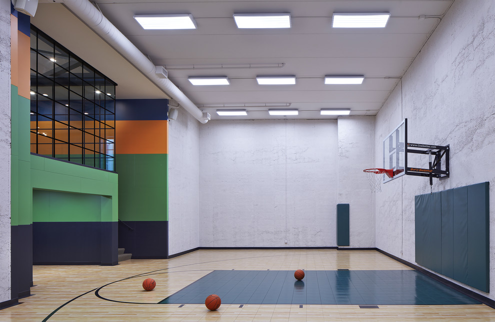 Large contemporary indoor sports court in Minneapolis with grey walls, beige floors and feature lighting.
