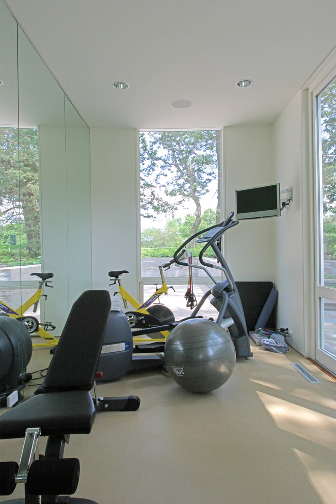 Inspiration for a contemporary home gym in Milwaukee with white walls.