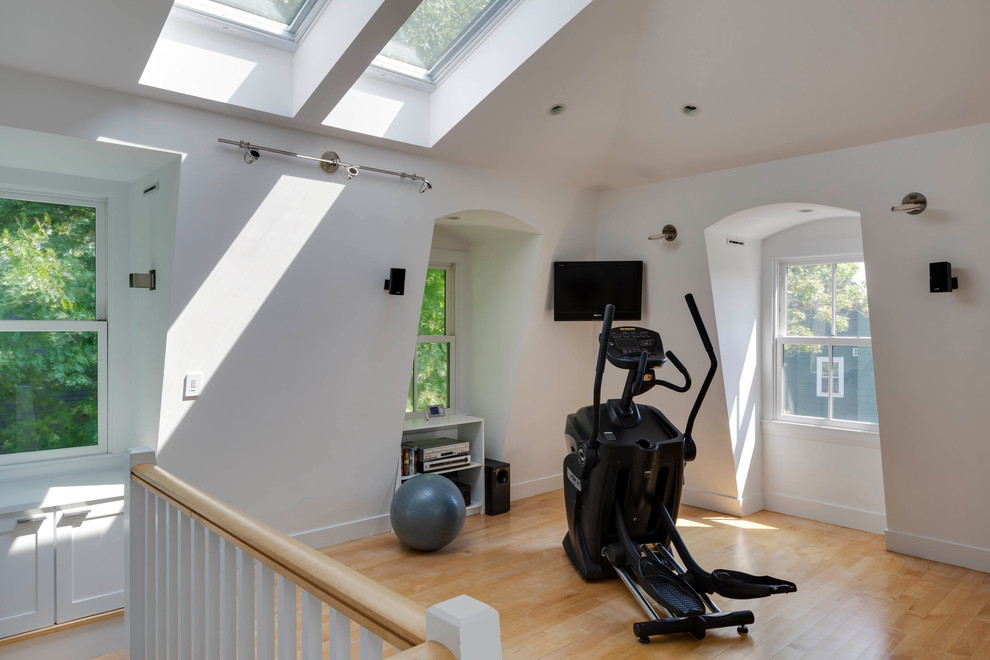 Design ideas for a medium sized modern multi-use home gym in Boston with white walls and light hardwood flooring.