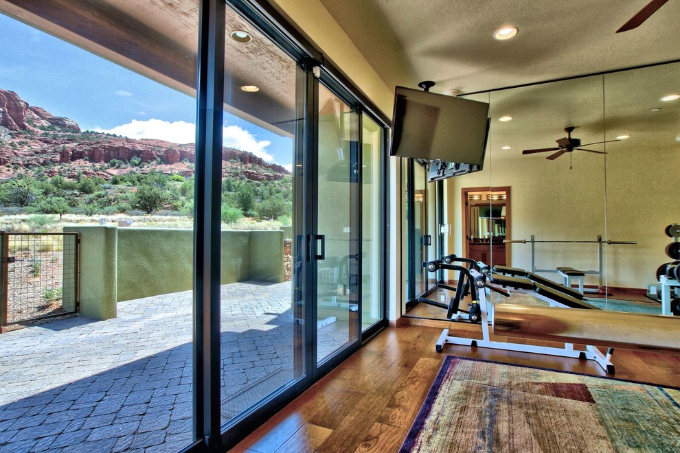 Photo of a medium sized home weight room in Phoenix with beige walls and medium hardwood flooring.