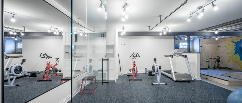 This is an example of a large industrial multi-use home gym in Ottawa with white walls.