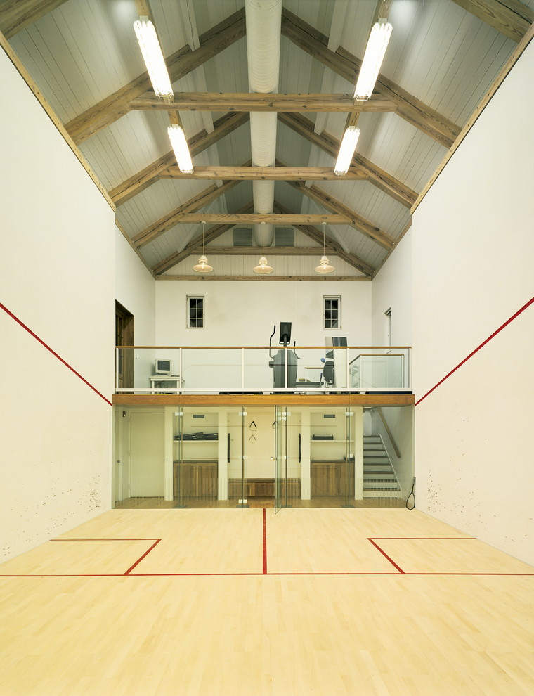 Großer Landhaus Fitnessraum mit Indoor-Sportplatz, weißer Wandfarbe und hellem Holzboden in New York
