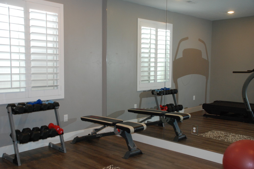 Example of a mid-sized transitional medium tone wood floor and brown floor multiuse home gym design in Salt Lake City with gray walls