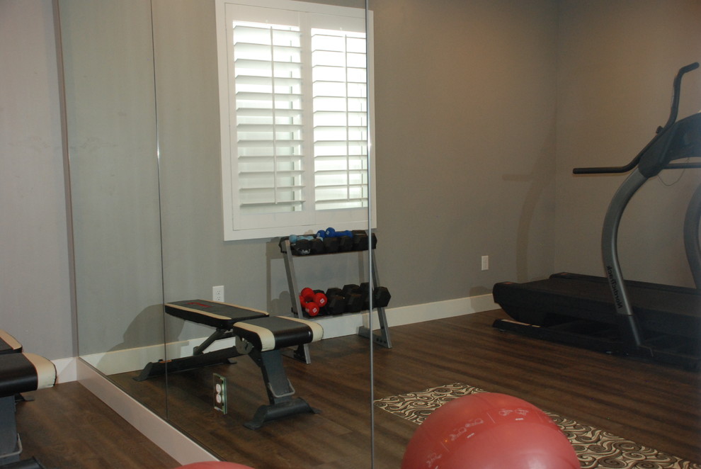 Photo of a medium sized traditional multi-use home gym in Salt Lake City with grey walls, medium hardwood flooring and brown floors.