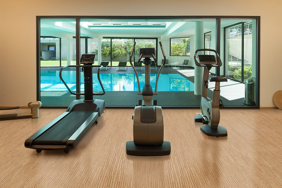 Photo of a mediterranean multi-use home gym in Omaha with brown walls, cork flooring and brown floors.