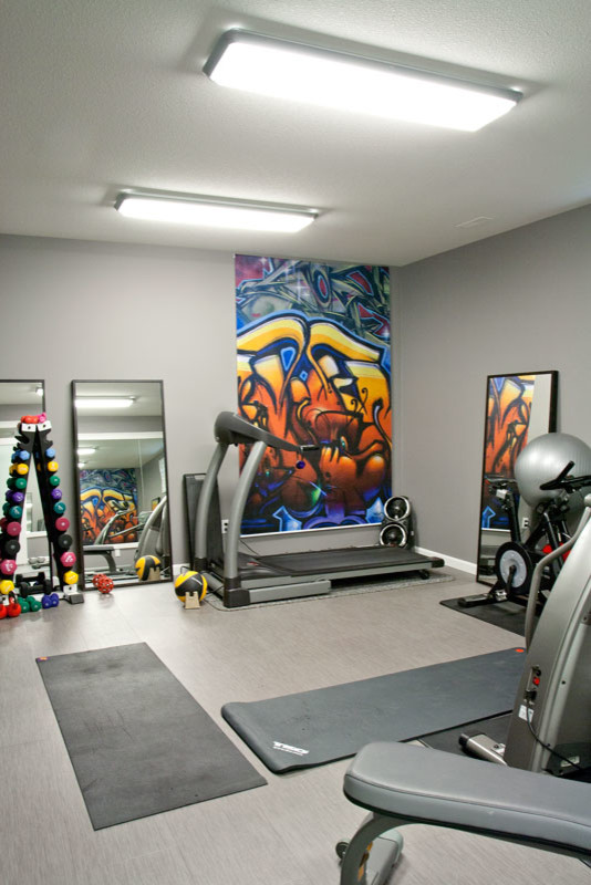 Ejemplo de gimnasio multiusos minimalista grande con paredes grises y suelo de corcho