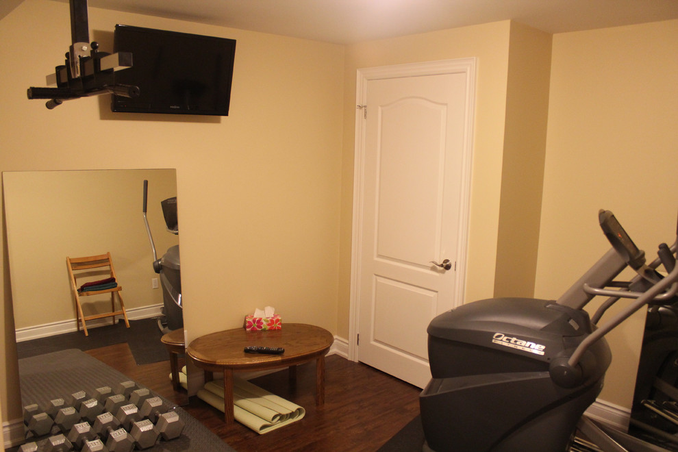 Example of a small classic dark wood floor home gym design in Toronto with beige walls