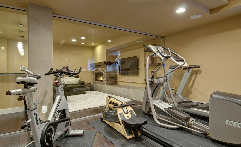 Medium sized classic multi-use home gym in Denver with beige walls, dark hardwood flooring and brown floors.