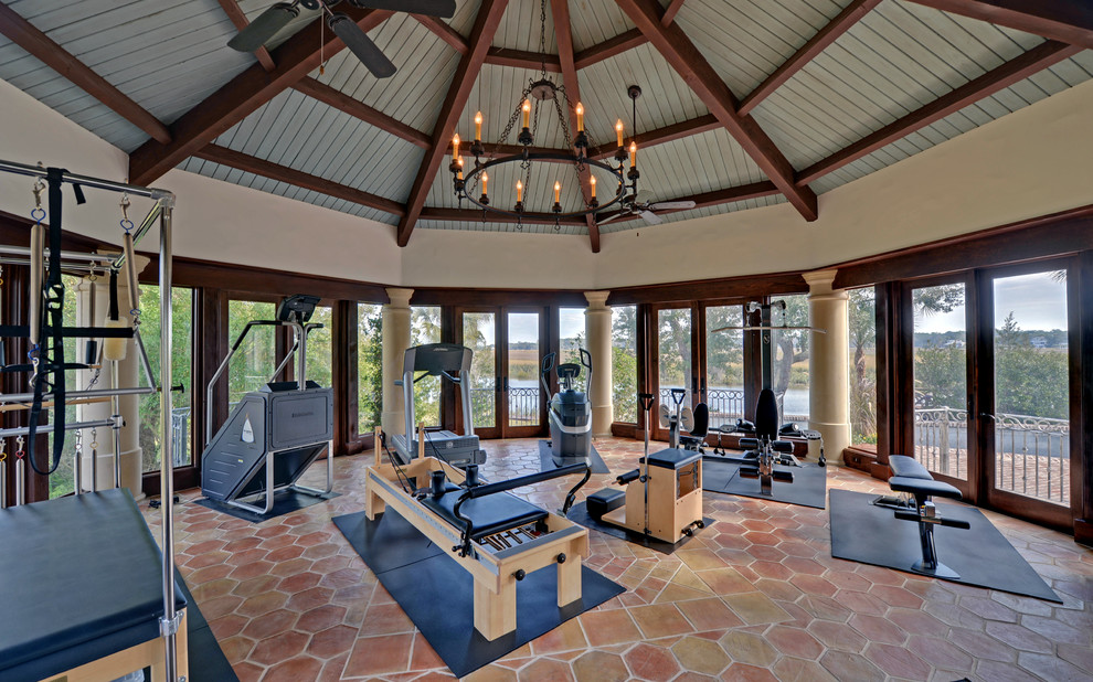 Inspiration for a large mediterranean terra-cotta tile and red floor multiuse home gym remodel in Atlanta with beige walls