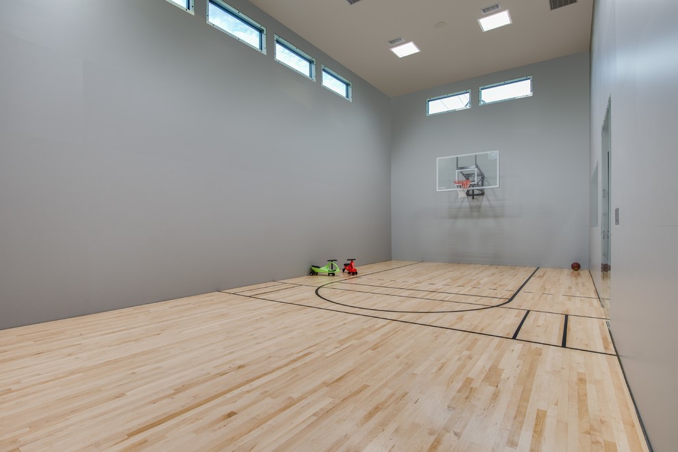 Inspiration for a medium sized traditional indoor sports court with grey walls, light hardwood flooring and beige floors.