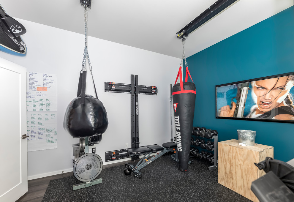 Home weight room - mid-sized modern cork floor and black floor home weight room idea in Seattle with blue walls