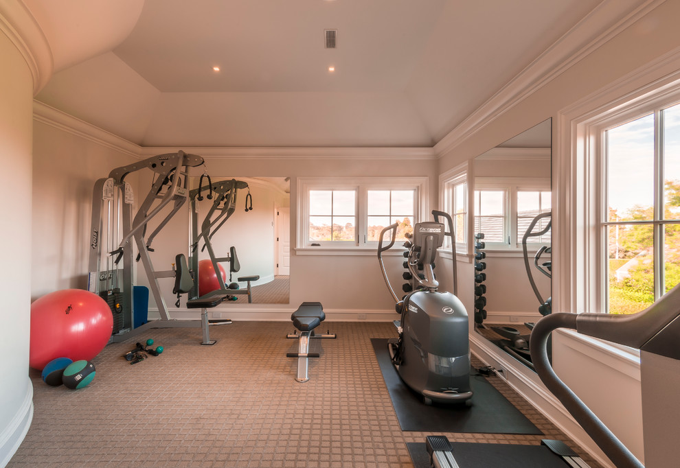 This is an example of a medium sized classic home weight room in New York with carpet and beige floors.