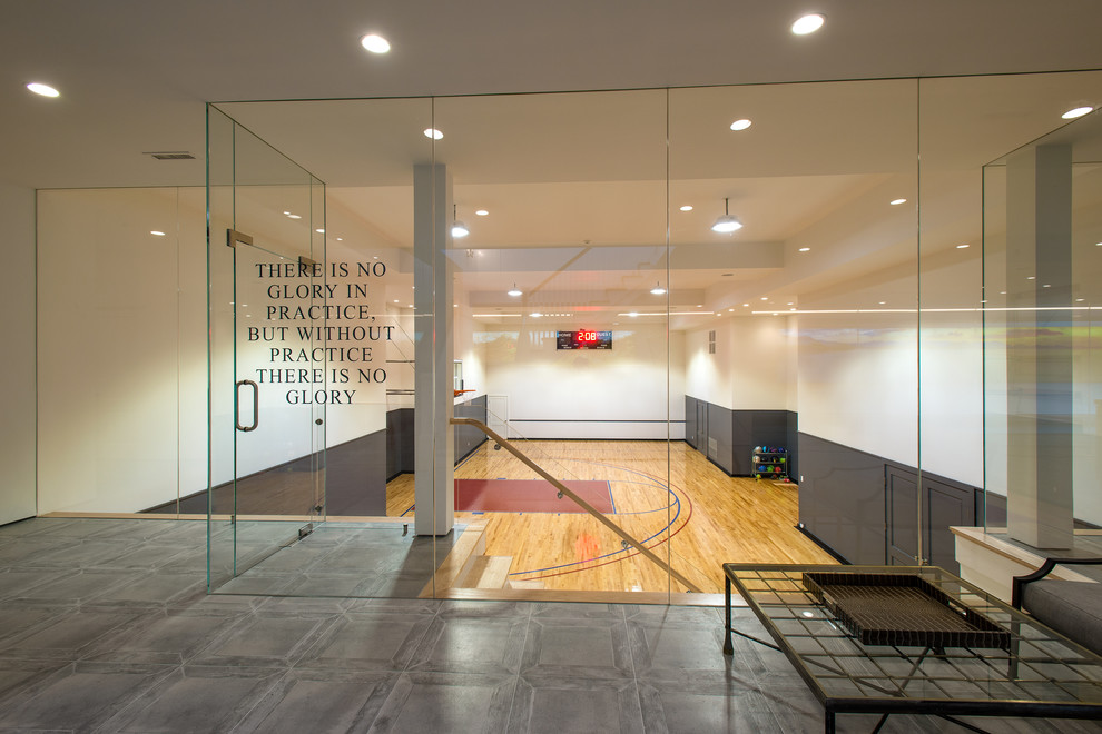 This is an example of a traditional indoor sports court in New York with white walls.