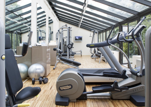 Inspiration for a huge light wood floor home weight room remodel in Phoenix with white walls