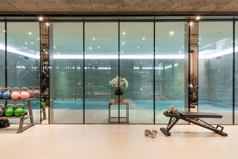 Design ideas for a contemporary multi-use home gym in London with white floors.