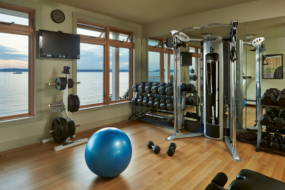 Design ideas for a beach style home gym in Seattle with orange floors.