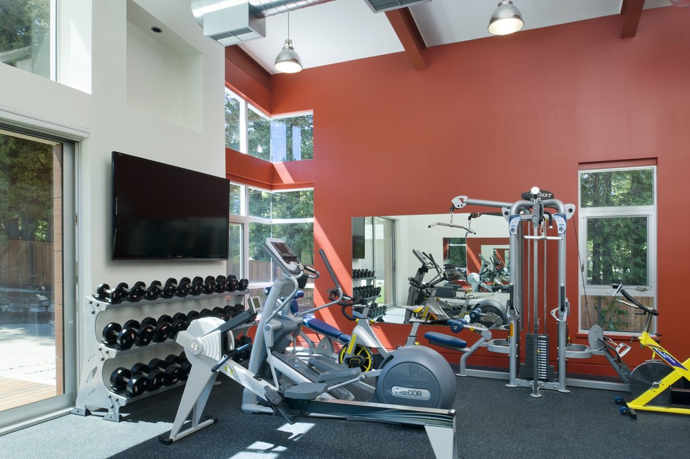 Design ideas for a contemporary multi-use home gym in San Francisco with red walls, grey floors and feature lighting.