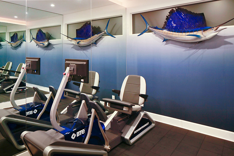 This is an example of a small contemporary multi-use home gym in Los Angeles with blue walls and black floors.