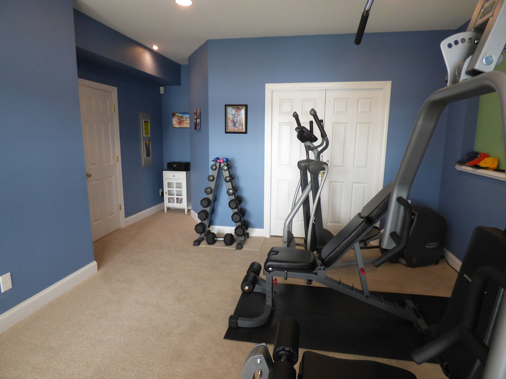 Inspiration for a mid-sized carpeted home weight room remodel in Other with blue walls