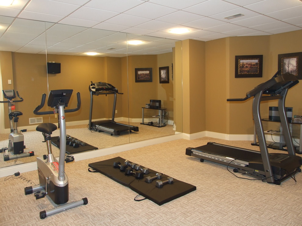 Example of a mid-sized arts and crafts carpeted home weight room design in Cleveland with brown walls
