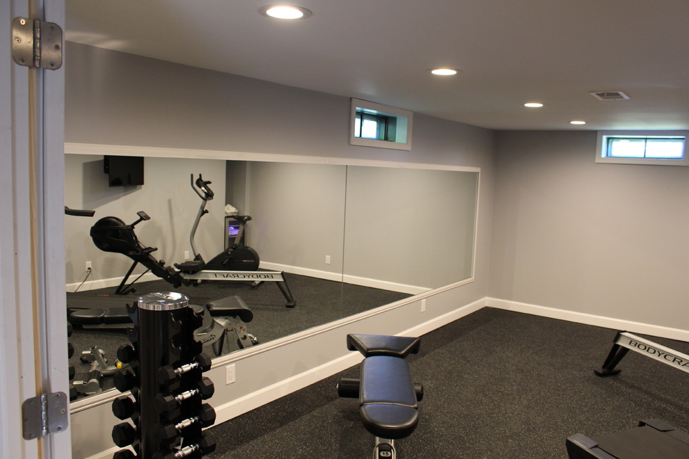 This is an example of a medium sized classic multi-use home gym in Detroit with grey walls.