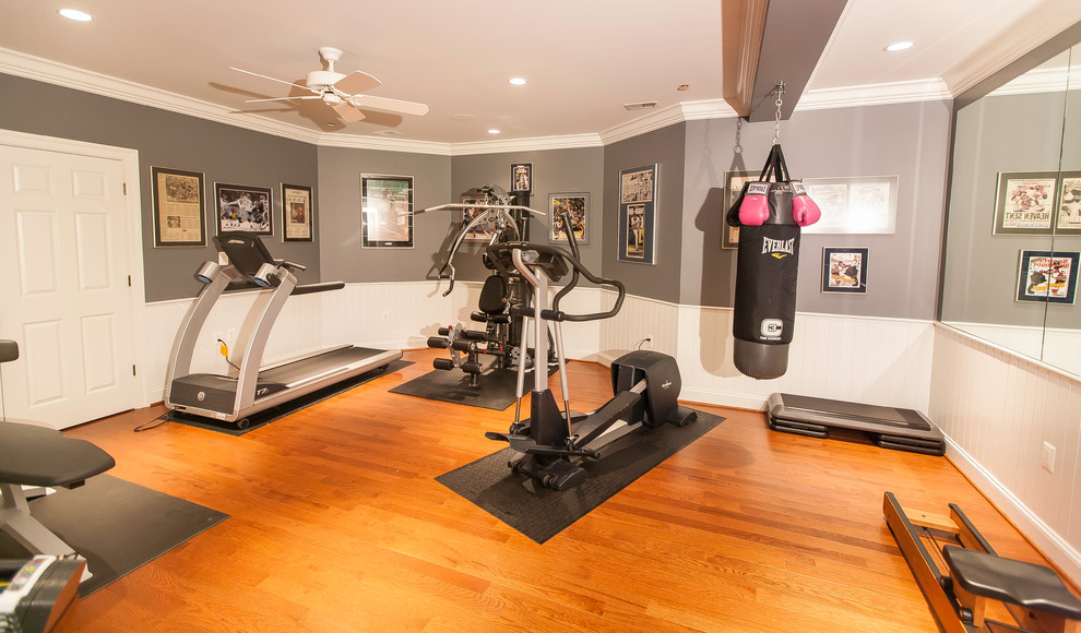Home gym with large mirror and bright lighting Traditional Home Gym