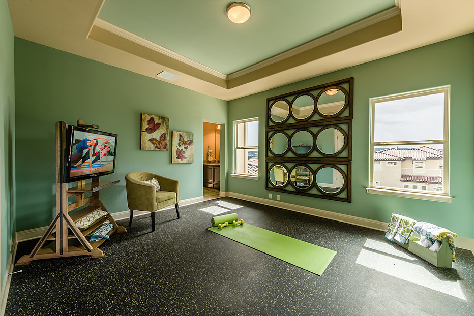 This is an example of a medium sized mediterranean home yoga studio in Austin with green walls and vinyl flooring.