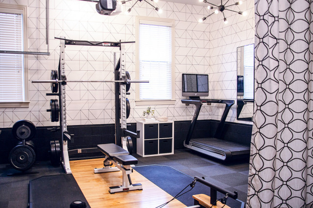 home gym with large equipment and bright curtains home gym with large equipment and bright curtains