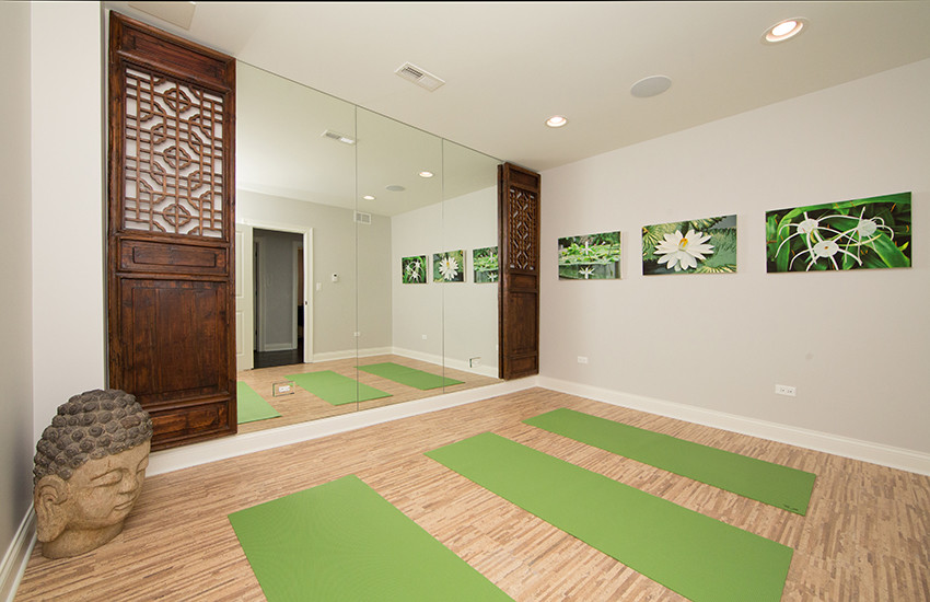 Medium sized home yoga studio in Chicago with grey walls, bamboo flooring, beige floors and a feature wall.