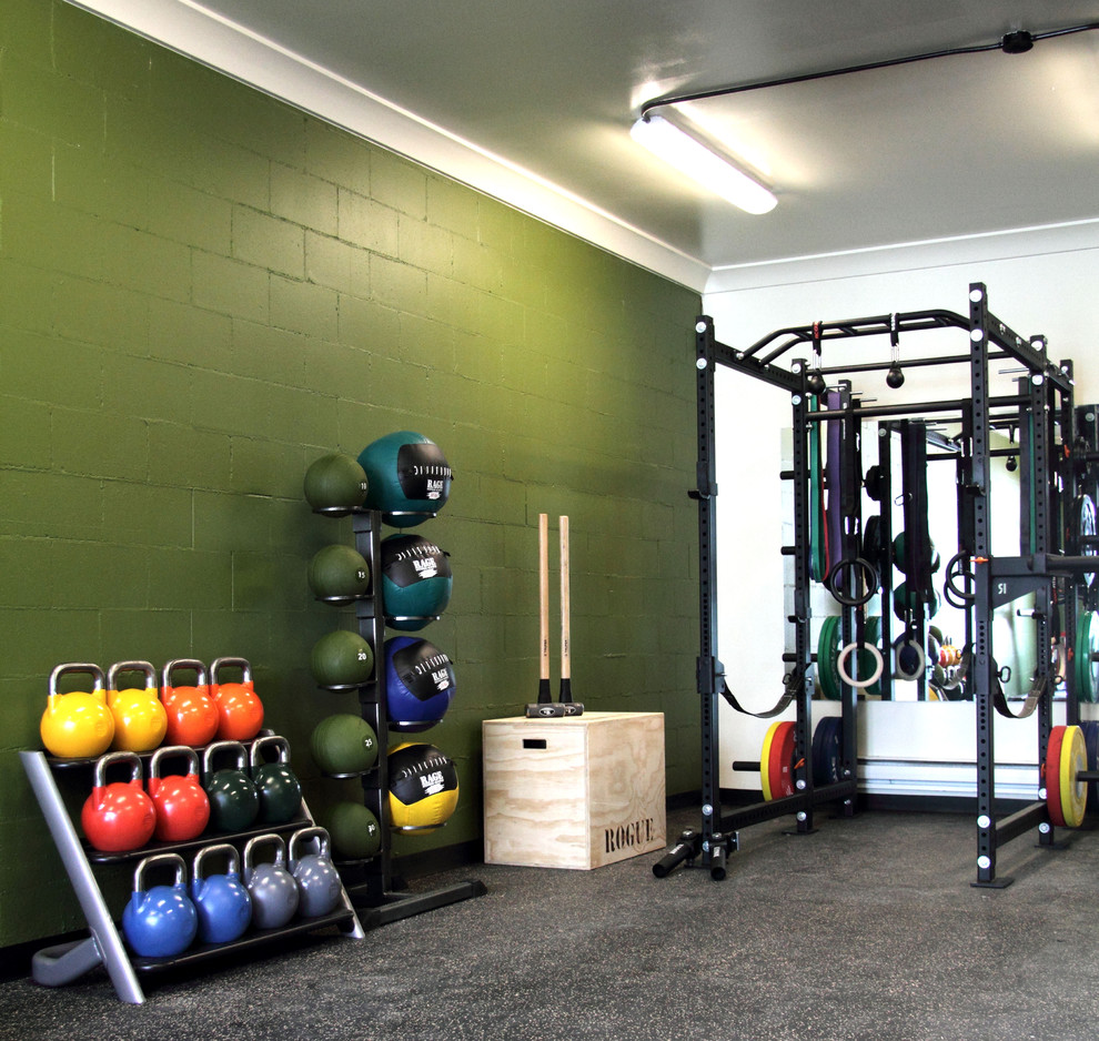 This is an example of a small contemporary home weight room in Calgary with green walls.