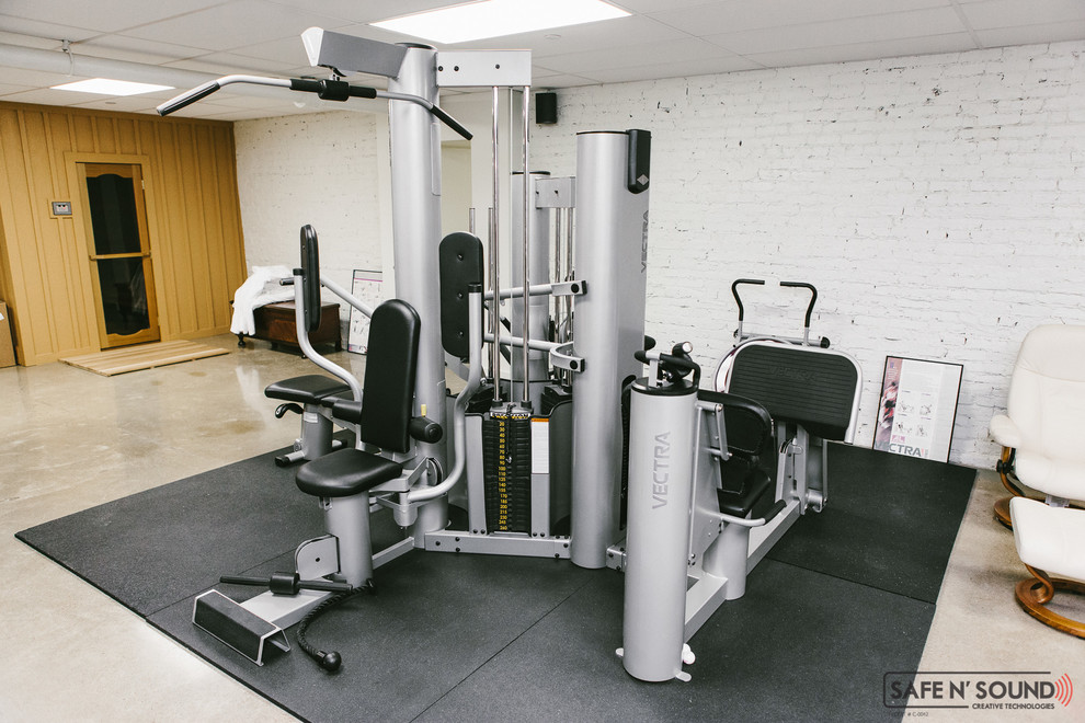 Home weight room - small contemporary light wood floor home weight room idea in Other with white walls