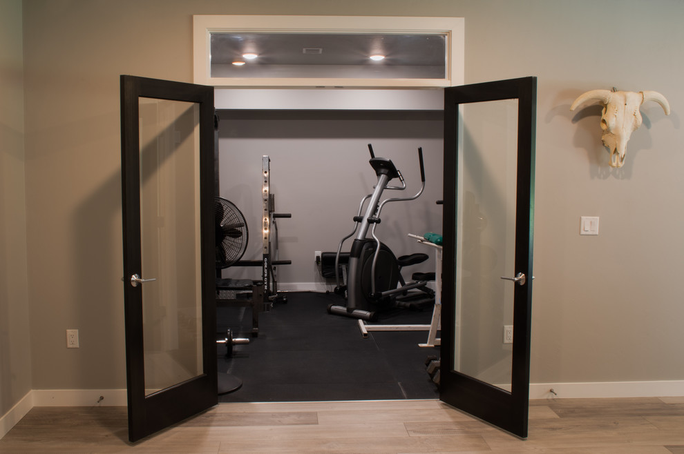 Example of a small urban light wood floor and brown floor multiuse home gym design in Other with gray walls