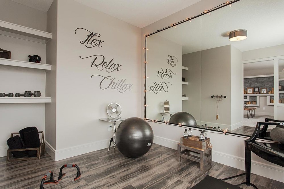 This is an example of a medium sized traditional multi-use home gym in Edmonton with grey walls, dark hardwood flooring and brown floors.