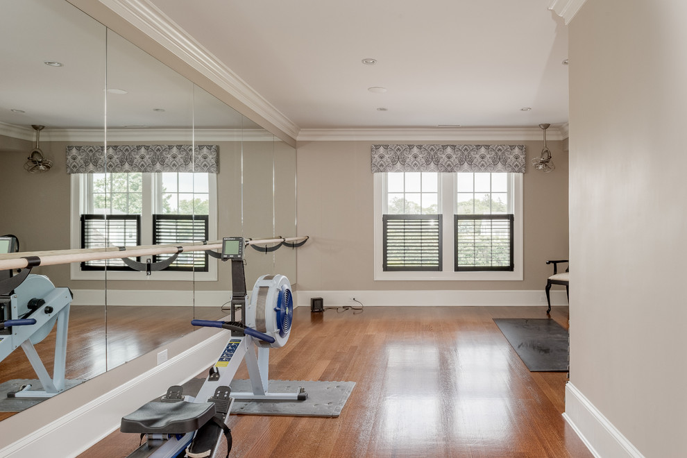 Example of a mid-sized beach style medium tone wood floor home weight room design in Bridgeport with beige walls